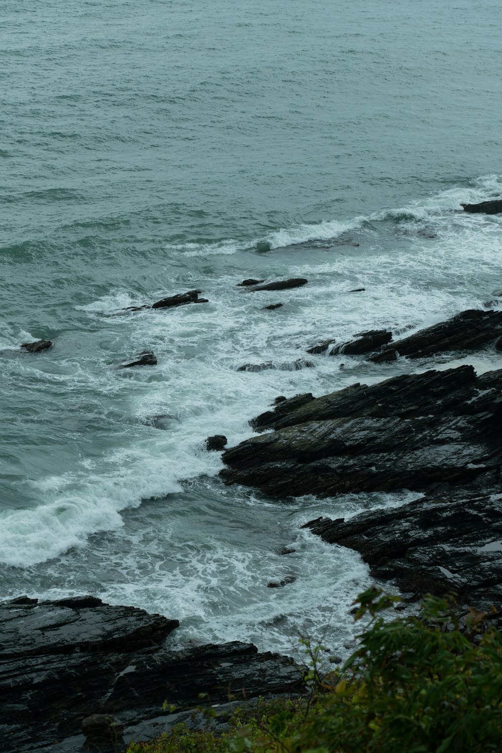 a rocky beach with waves crashing