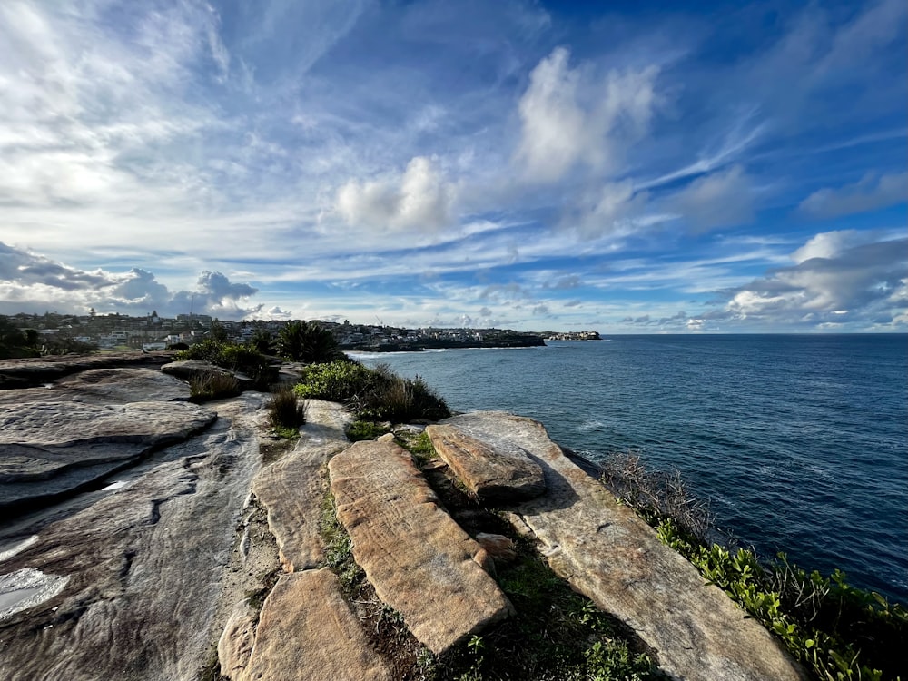 a rocky cliff overlooking a body of water