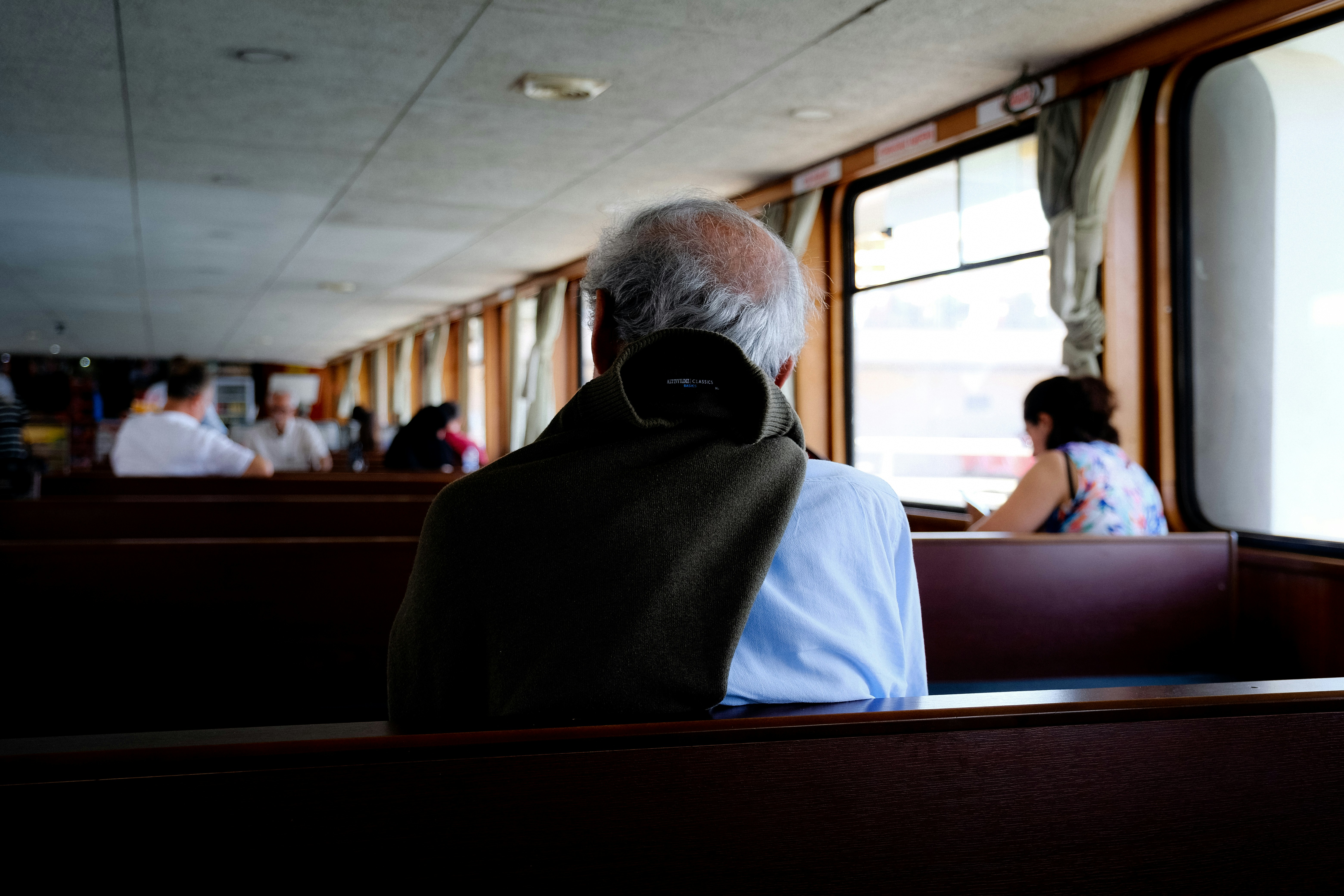 a person wearing a mask sitting on a bus, 