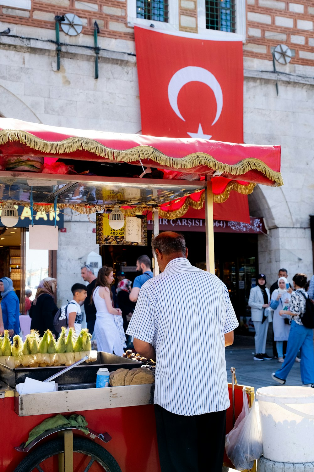 a person stands in front of a fruit stand