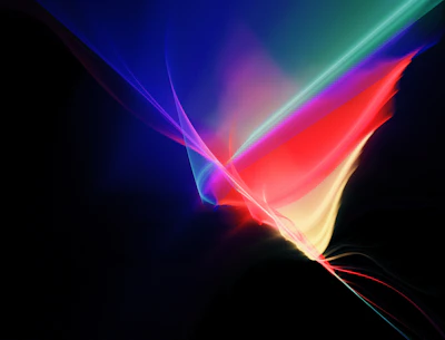 Vibrant, flowing patterns of light with a spectrum of colors including red, blue, green, and yellow against a dark background, creating an abstract and dynamic visual effect.