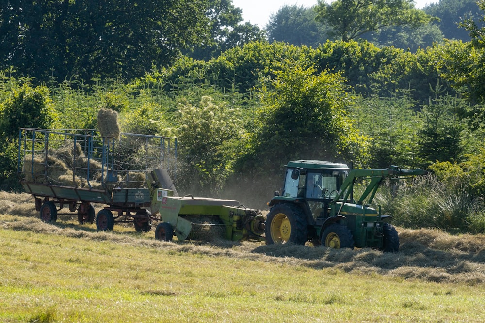 a tractor pulling a trailer full of hay