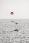 a person parasailing on a boat