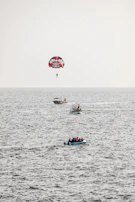 a person parasailing on a boat