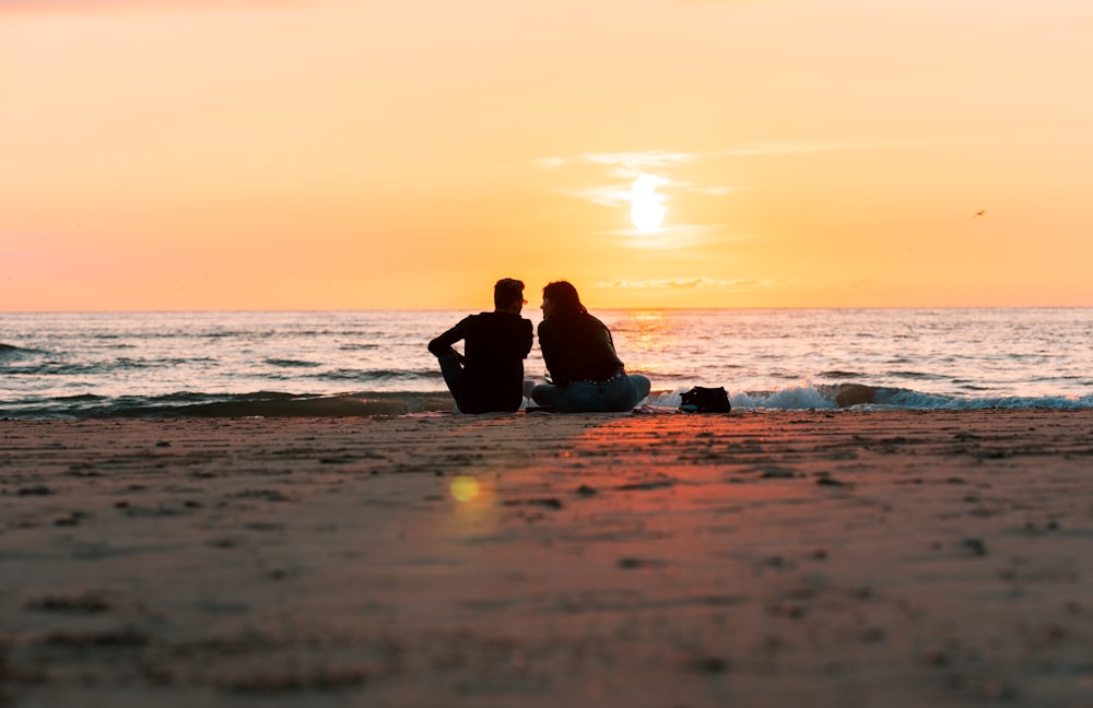 a couple sitting on a beach