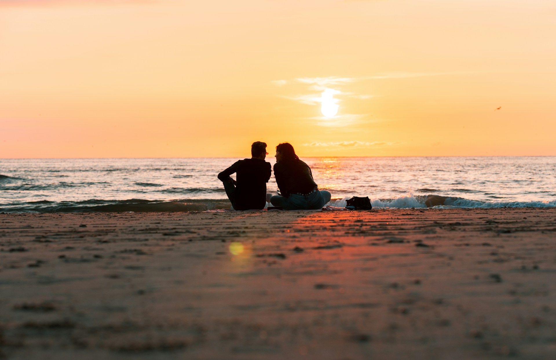 a couple sitting on a beach