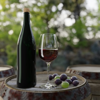 a bottle of wine and grapes on a table