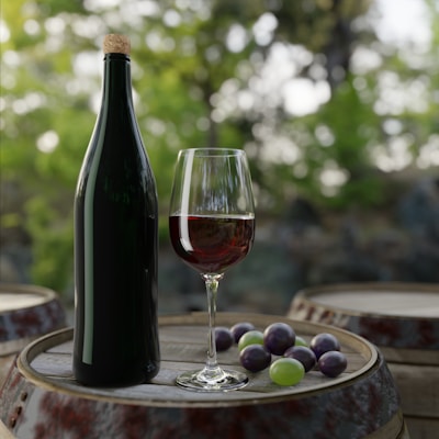 a bottle of wine and grapes on a table
