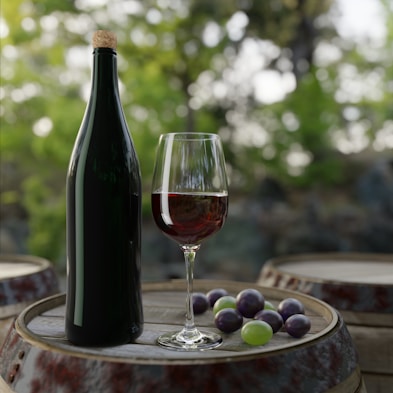 a bottle of wine and grapes on a table