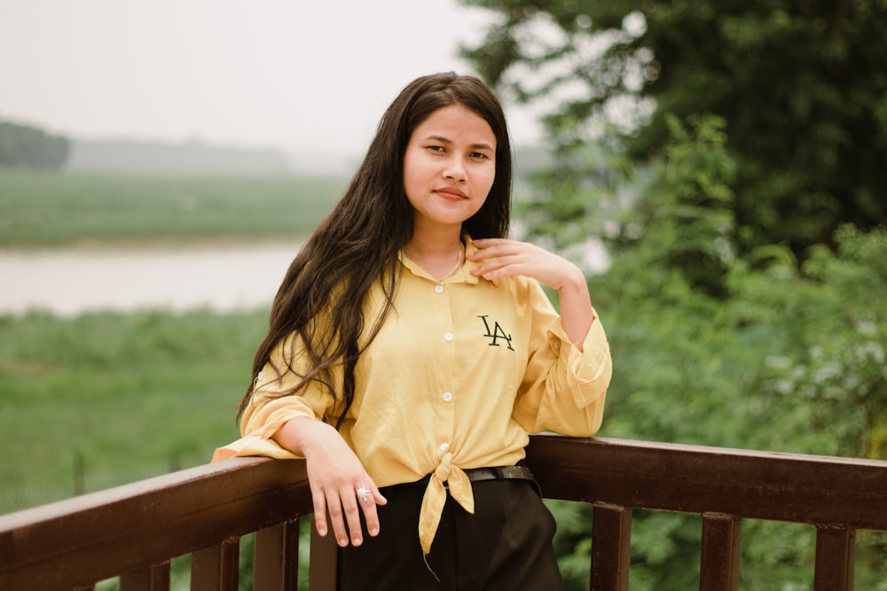 a woman leaning on a railing