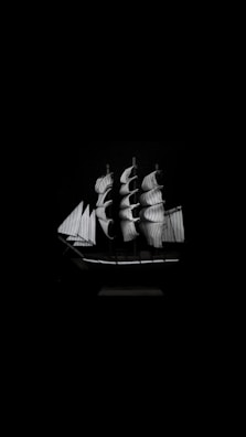 A detailed painting of a Spanish galleon sailing under a golden sunset.