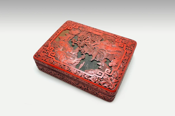 An elegant Japanese-inspired storage box with vivid red details on a clean white surface.