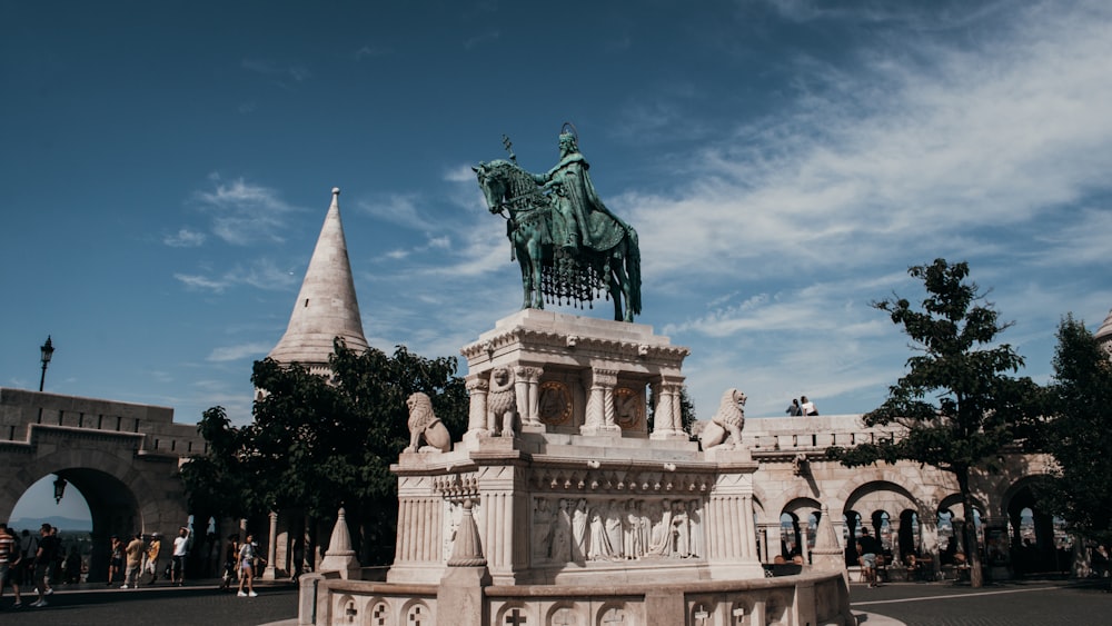 a statue of a person riding a horse on a building