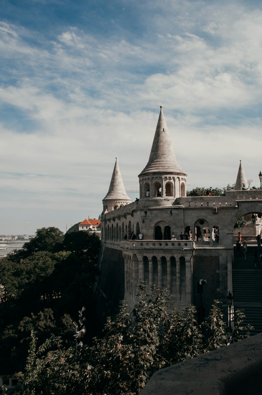 a castle with steeples and trees with Corvin Castle in the background