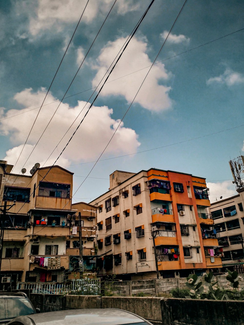 a group of buildings with wires above them