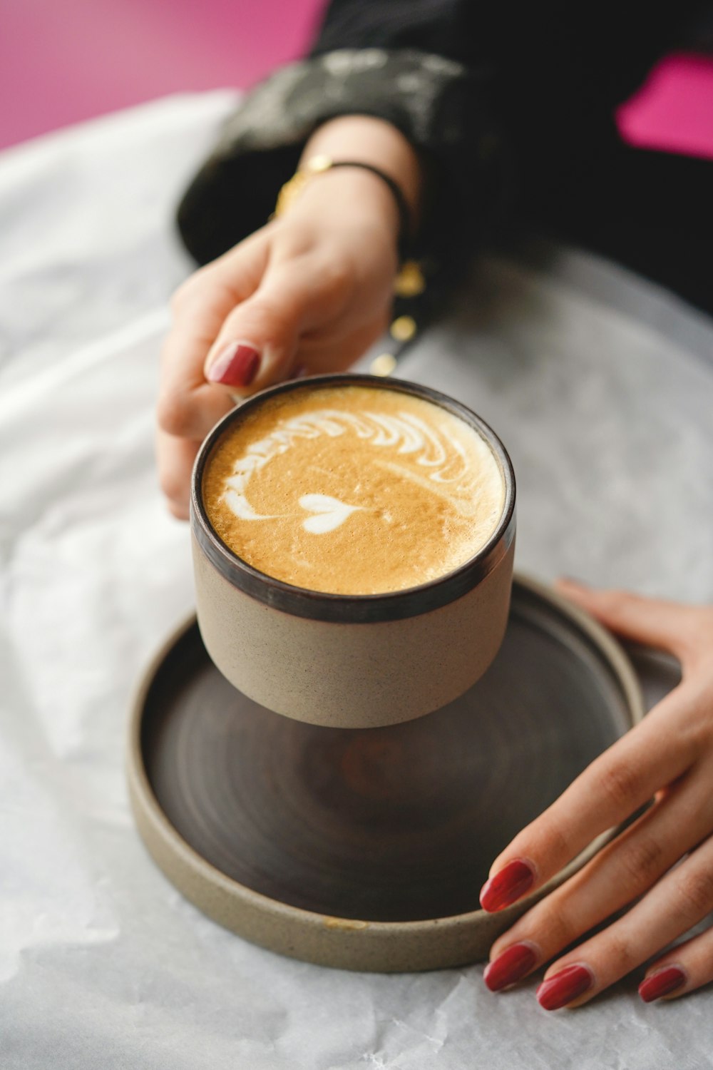 eine Person, die eine Tasse Kaffee hält