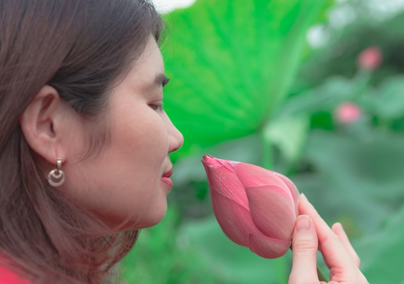 a woman smelling a flower