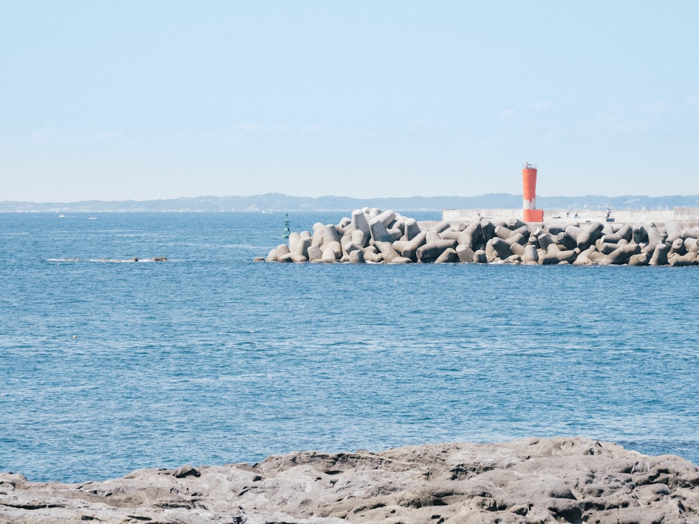 a rocky beach with a lighthouse