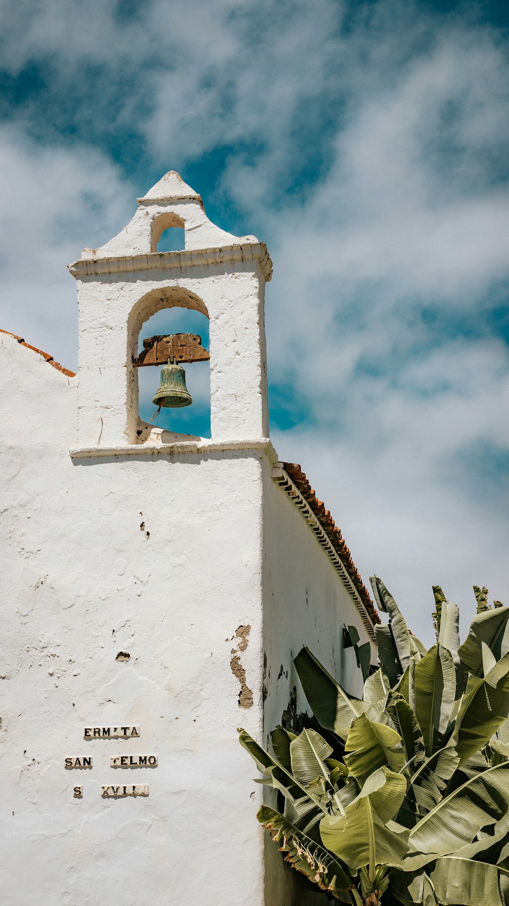 a bell on a white building