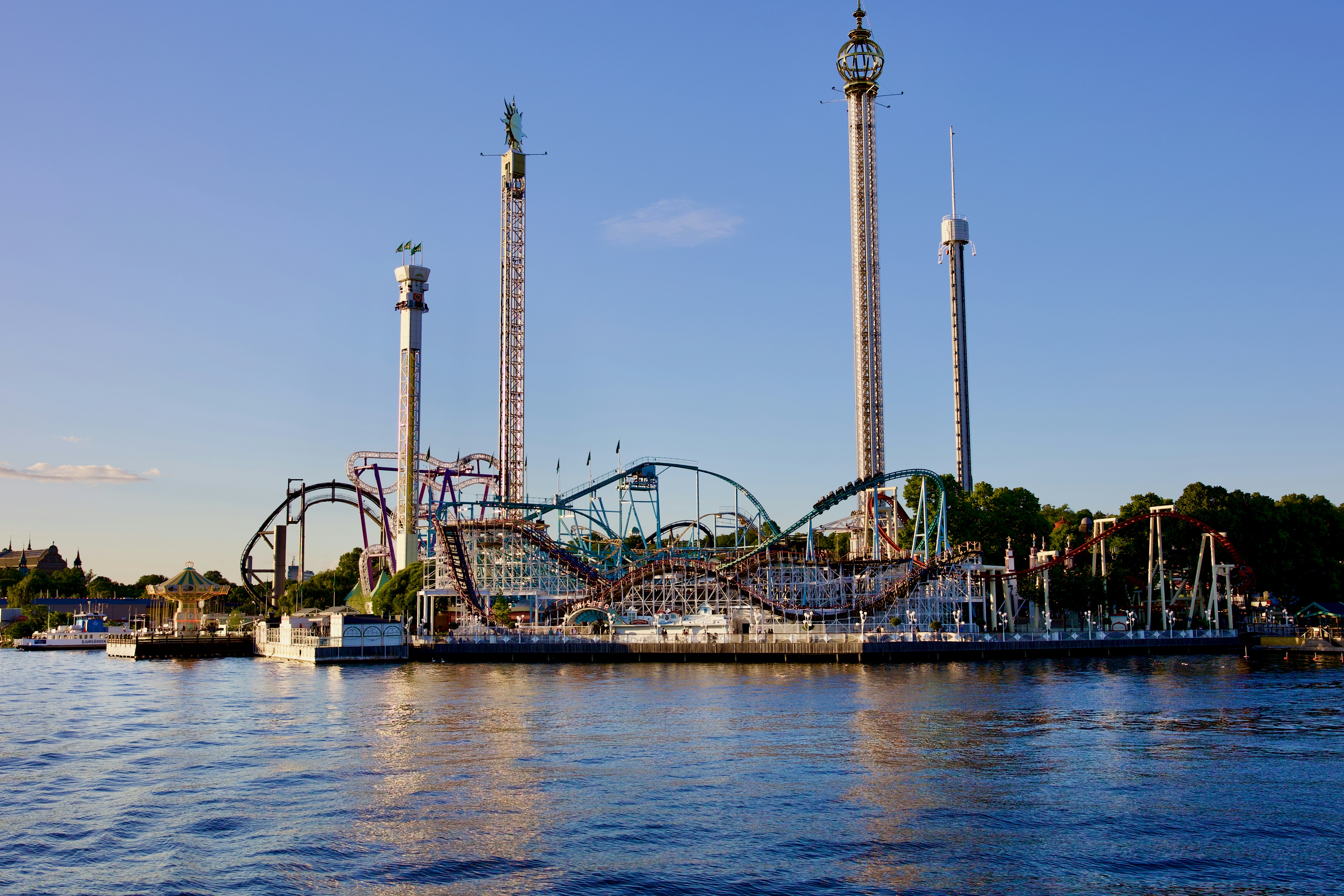 a roller coaster next to a body of water