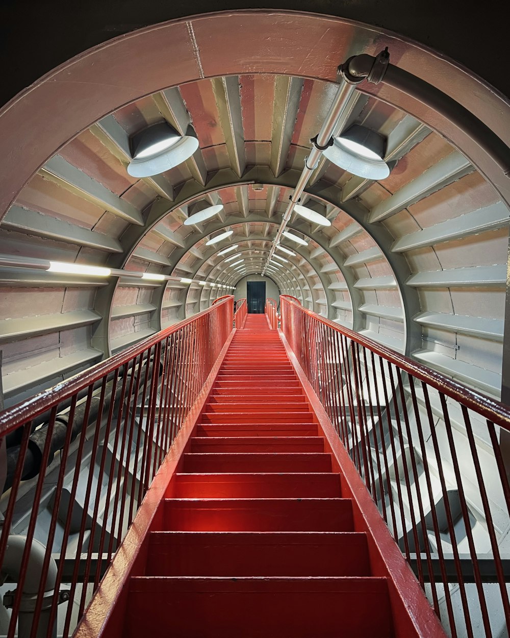 a staircase with red railings
