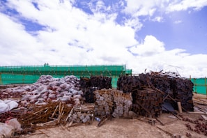 Wide shot of various construction materials lined up outdoors under clear blue skies.