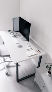 A sleek workspace with anime-inspired decor and gaming accessories arranged neatly.