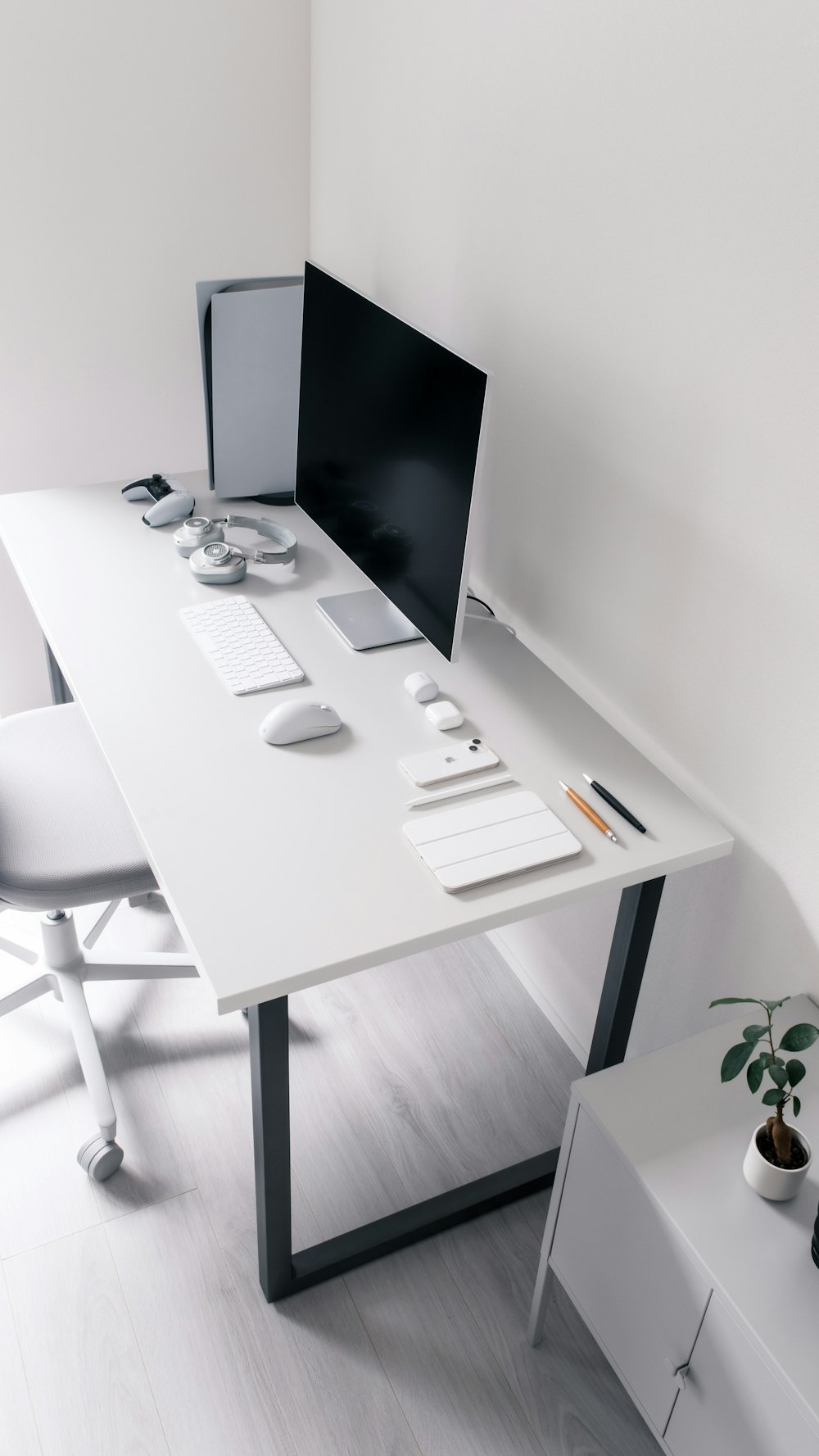 a desk with a computer and a chair