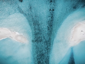 a large waterfall with snow on the sides