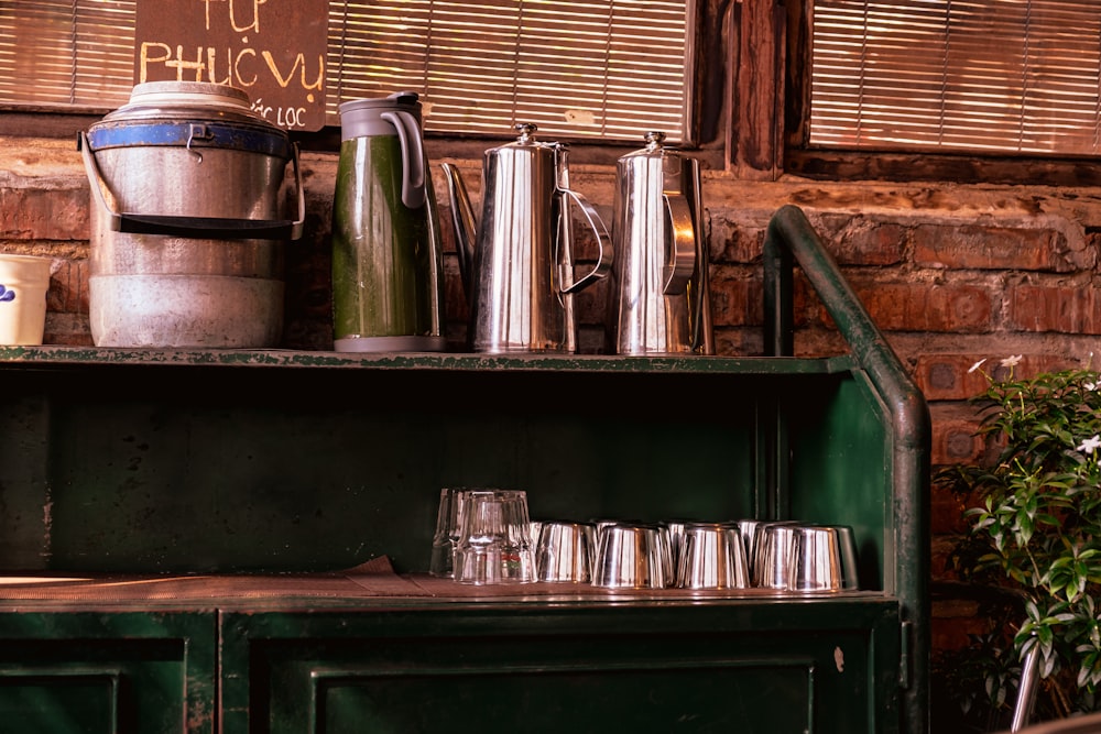 a shelf with pots and glasses on it