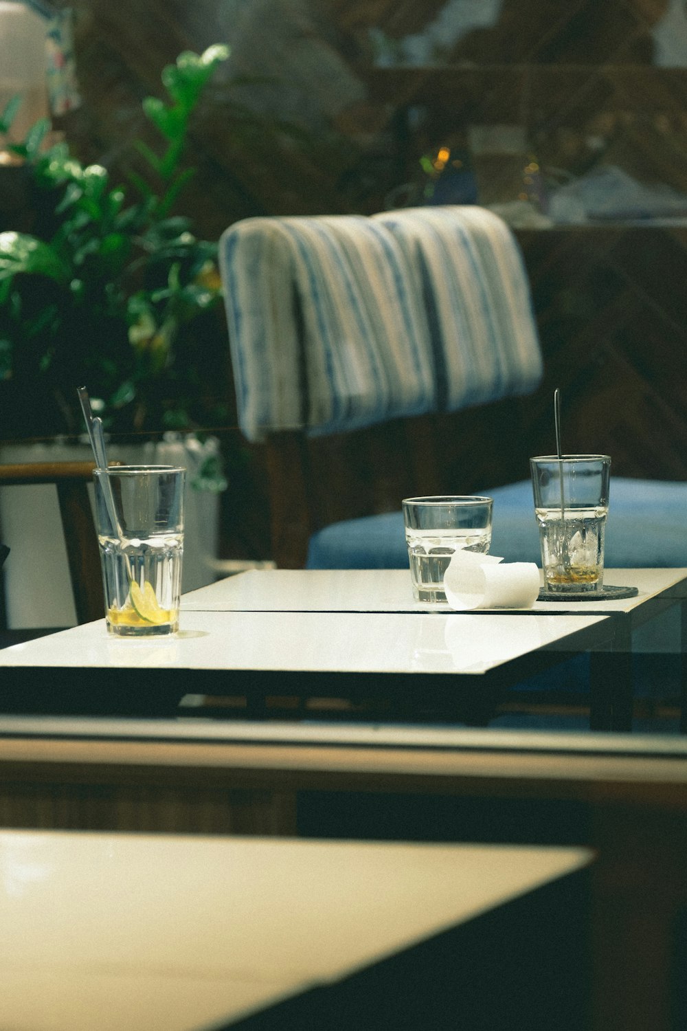 a table with glasses and a plant