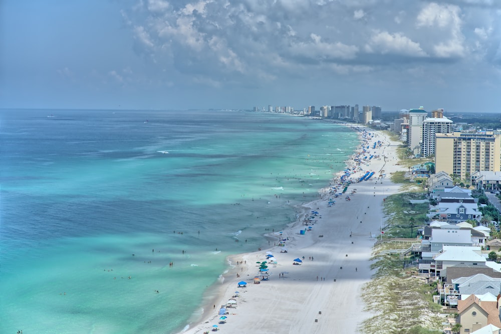 a beach with buildings and water