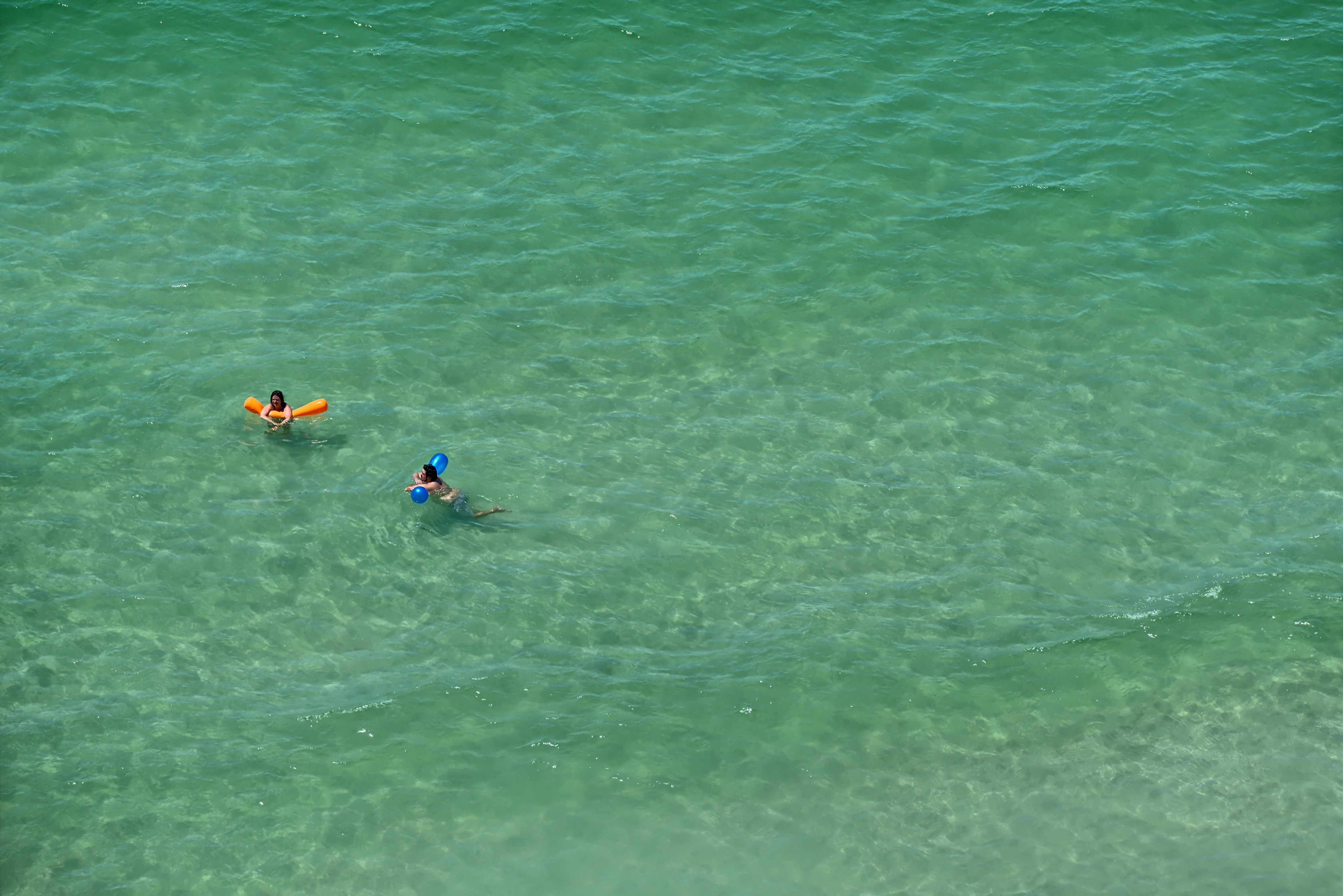 a couple people in a body of water