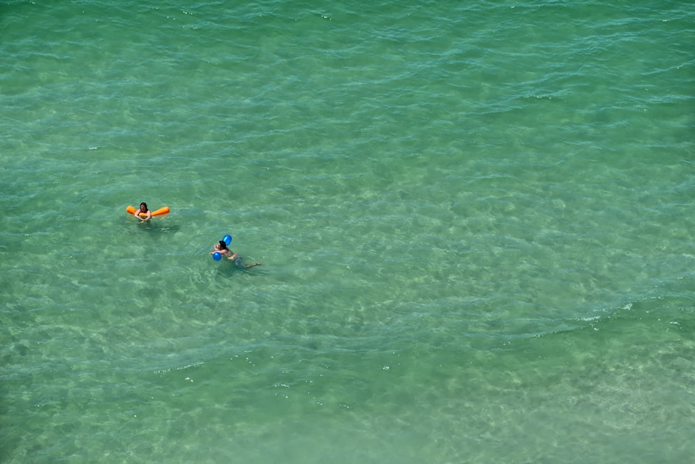 a couple people in a body of water