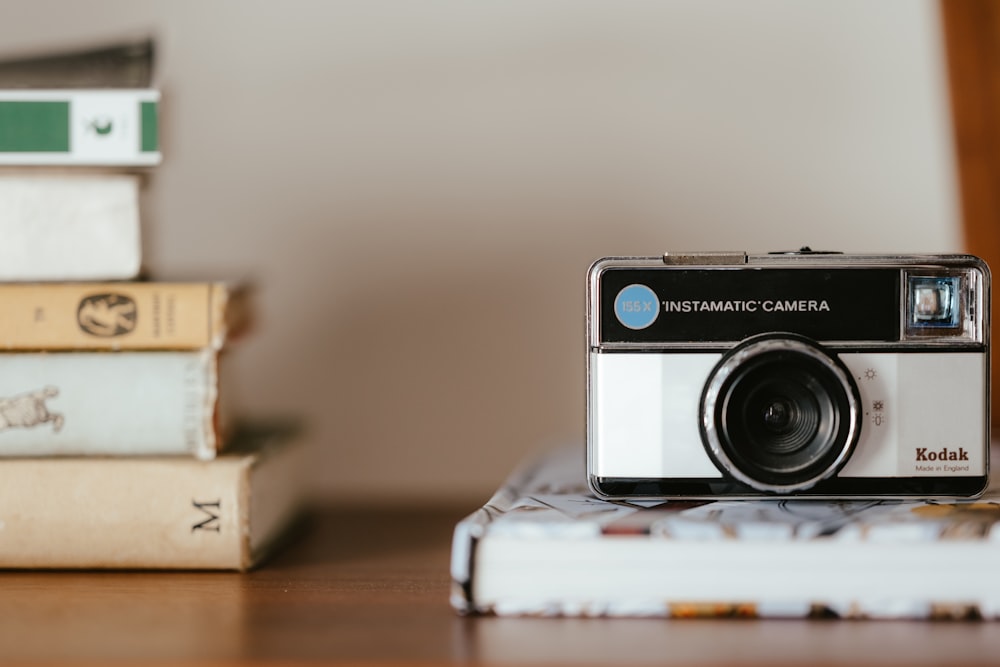 a camera on a stack of papers