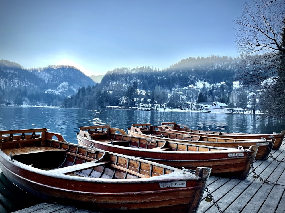 a group of boats sit on a dock