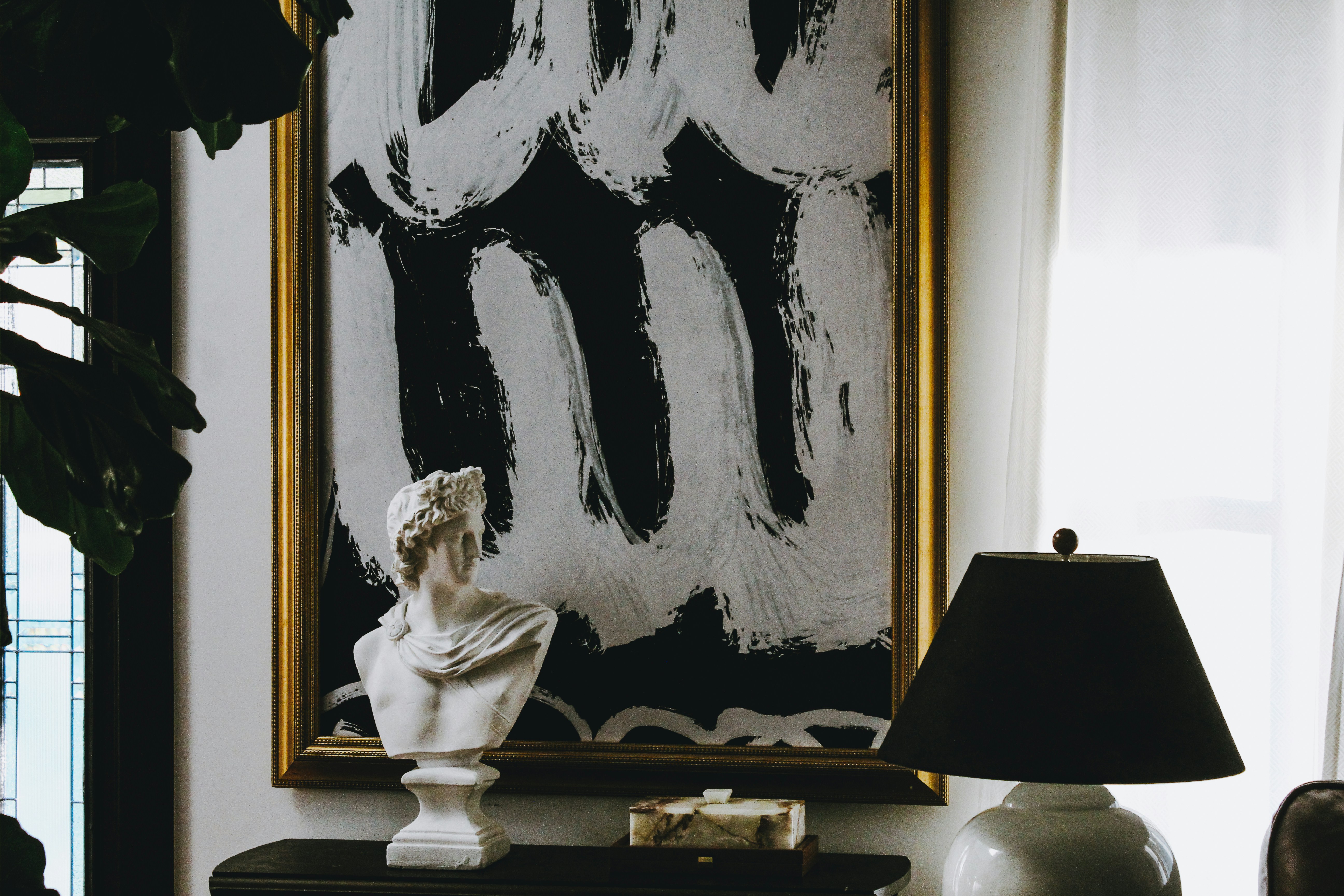 a statue in front of a painting