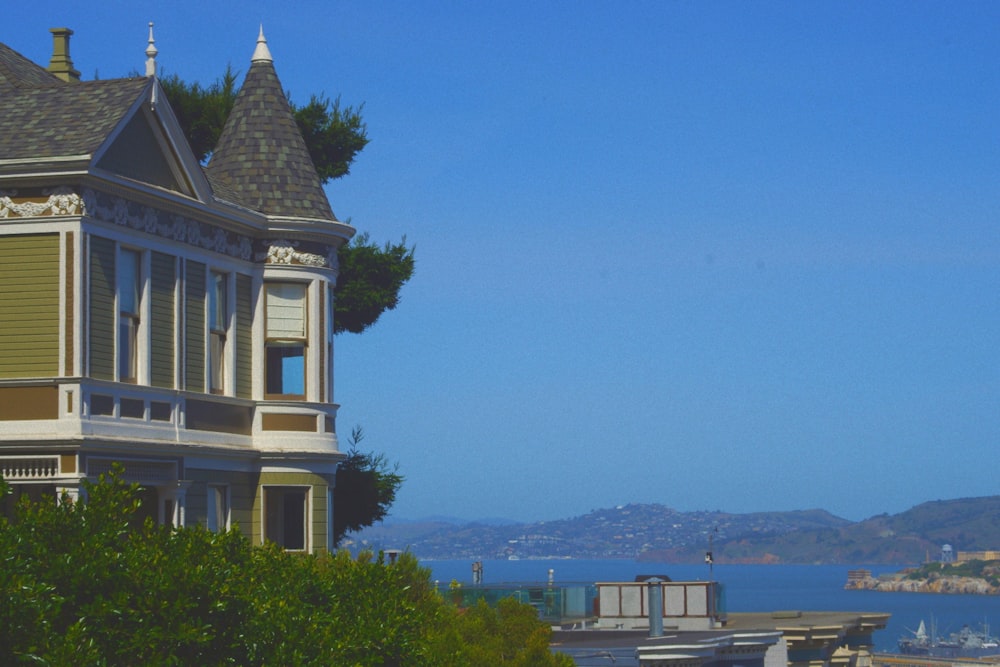 a building with a tower and trees in the background