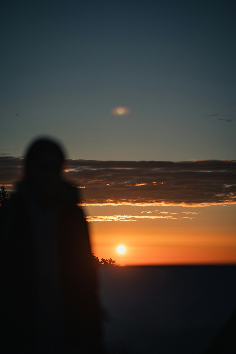 a person looking at the sunset