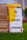 A stack of books is placed on green grass. The book in the foreground is titled 'The Minimalist Entrepreneur' by Sahil Lavingia, with a yellow and white cover. Other books in the stack include 'Do Epic Shit' by Ankur Warikoo and 'How to Win Friends and Influence People' by Dale Carnegie. The background is blurred, indicating an outdoor setting.