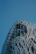 Architectural stainless steel mesh on a modern building facade.