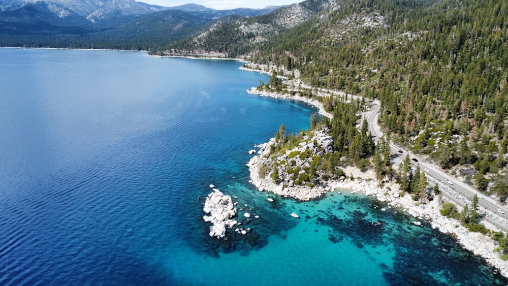 a body of water with trees and mountains around it