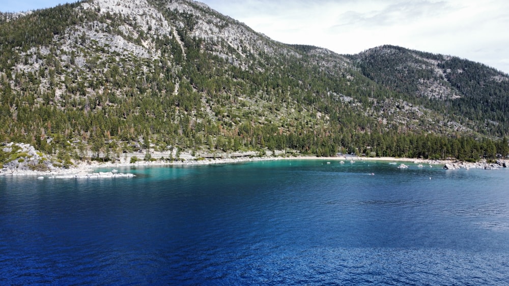 a body of water with a mountain in the background