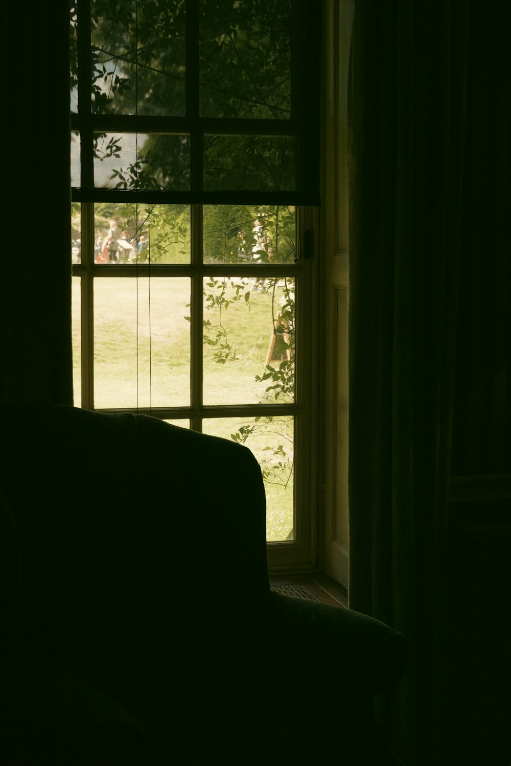 a window with a view of a group of people outside