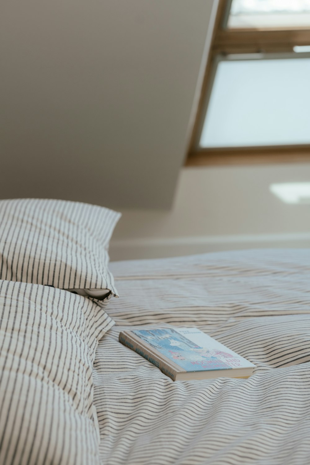 a stack of books on a bed