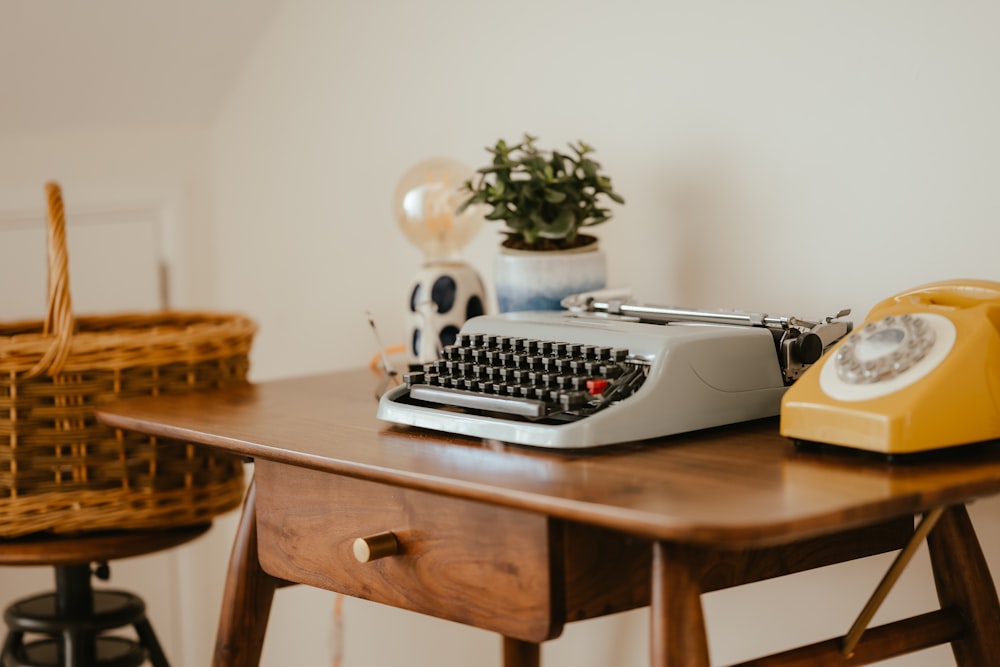 a table with a keyboard and a potted plant on it