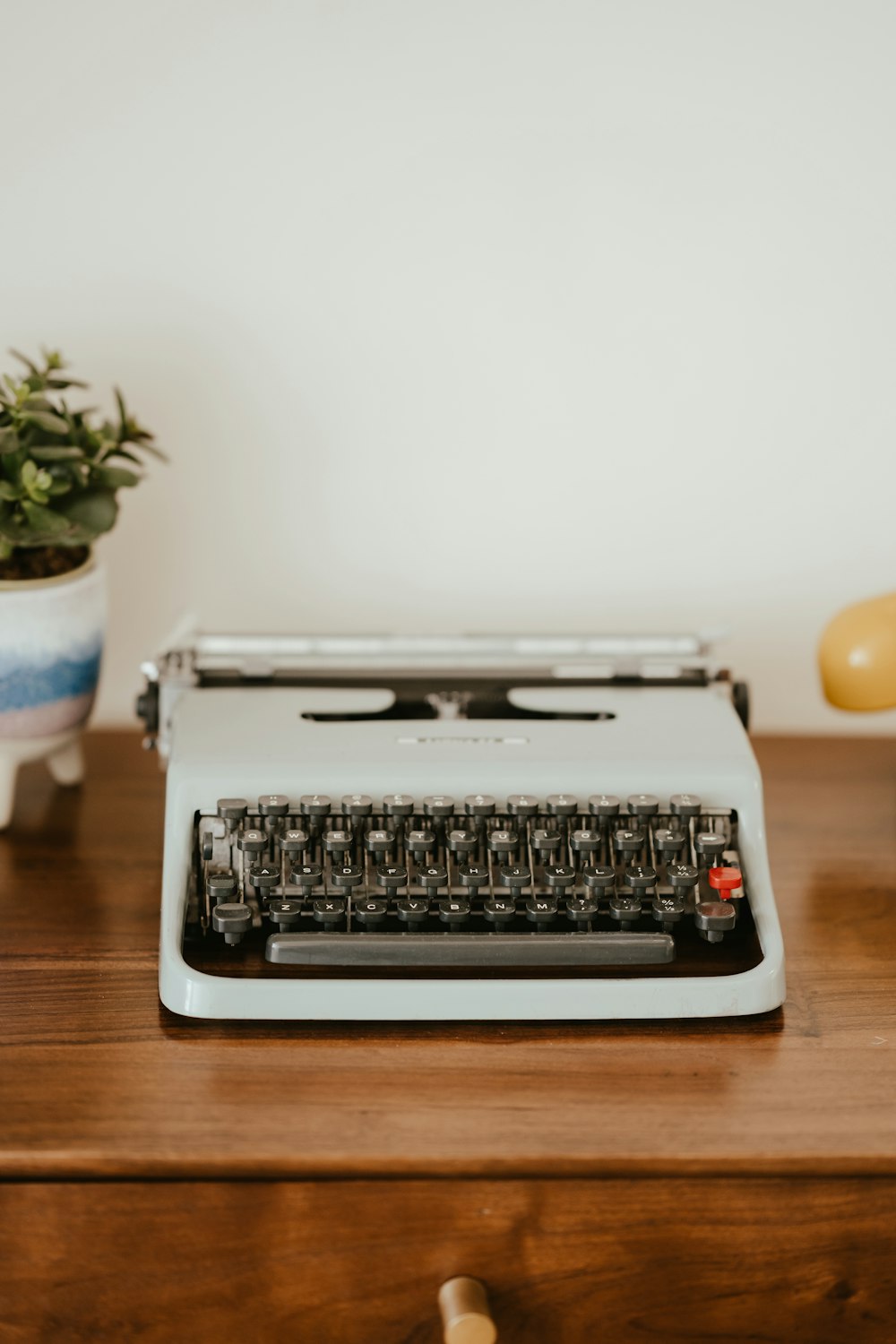 a black and silver typewriter on a wooden table