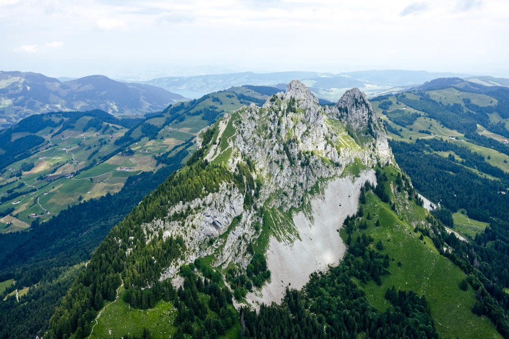 a large mountain with a waterfall