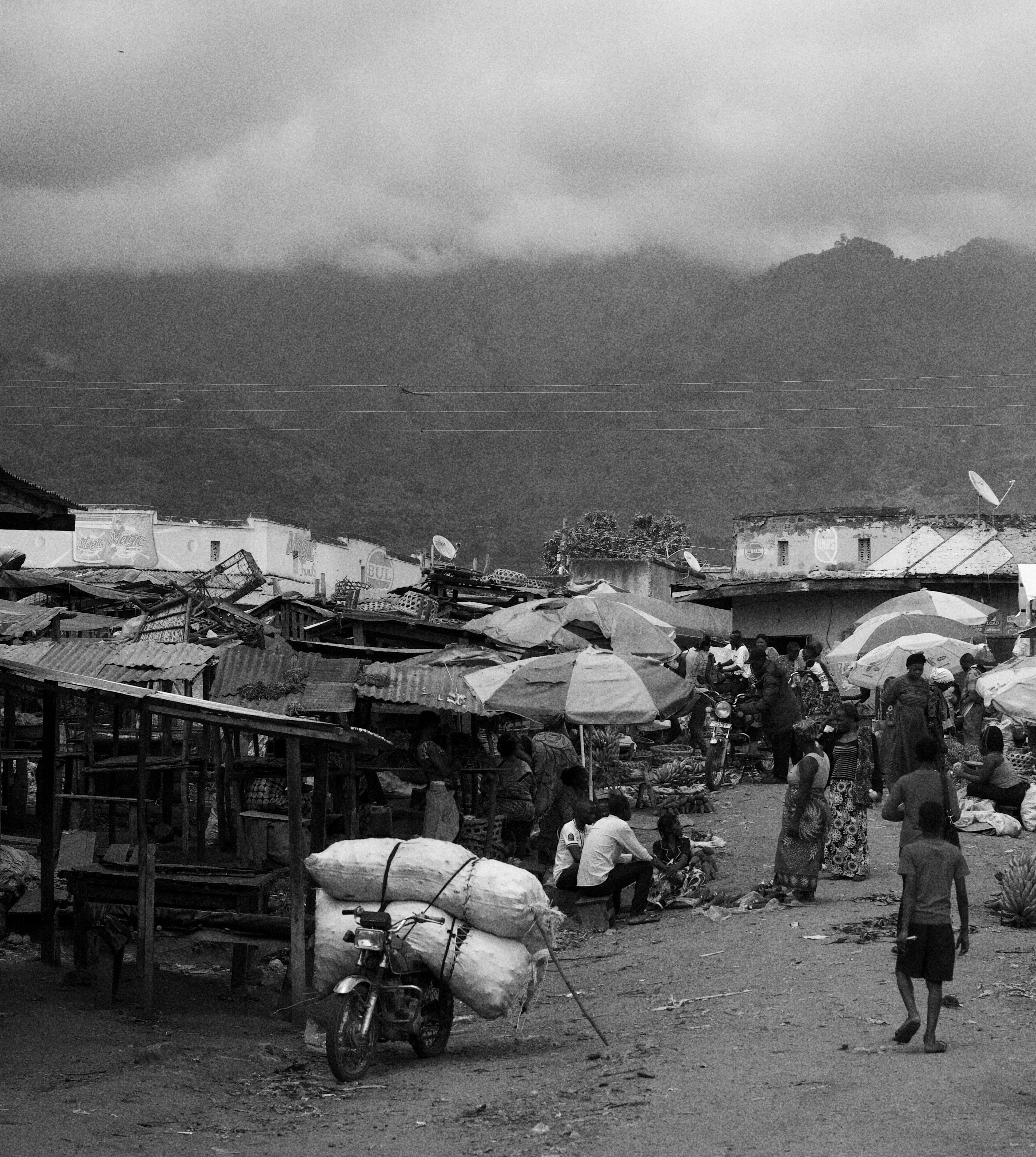 a group of people stand outside a small village