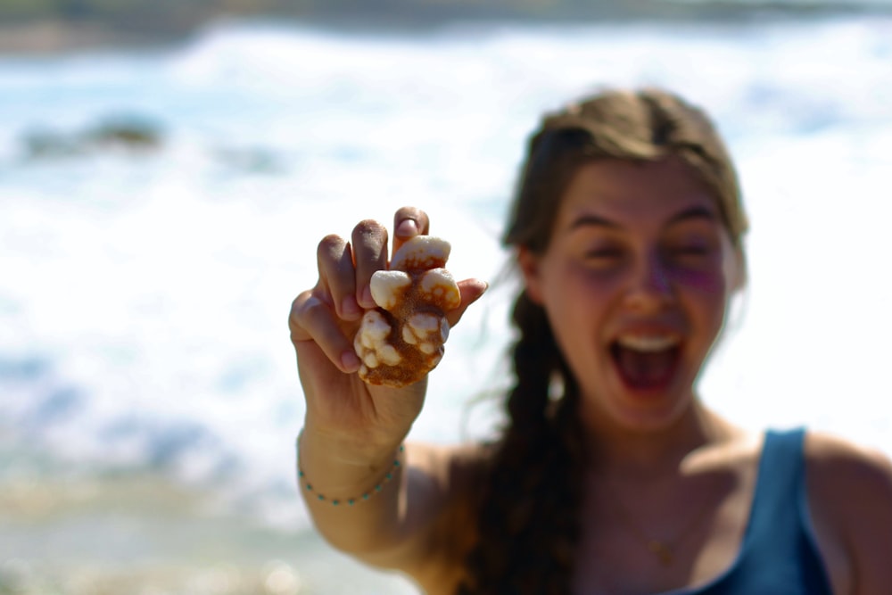 a woman holding a crab